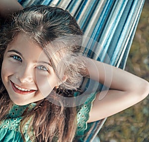 Cheerful girl resting on the hammock