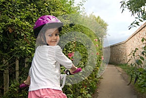 Cheerful girl riding a bike