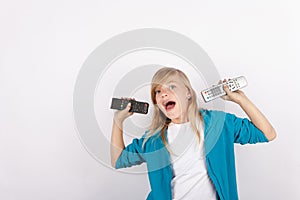 Cheerful girl showing remote controls