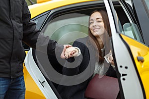 Cheerful girl sitting in taxi
