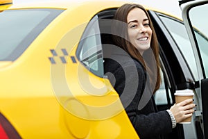 Cheerful girl sitting in taxi.