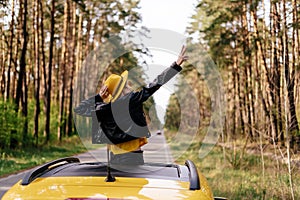 Cheerful Girl Stand out of Car Sunroof Back View