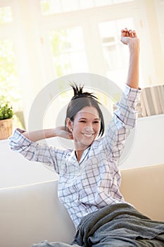 Cheerful girl stretching in morning