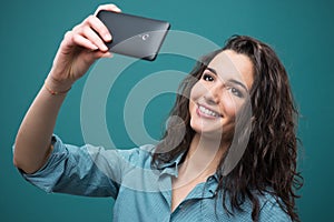 Cheerful girl taking a selfie