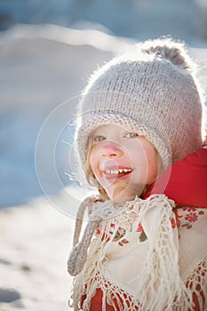 Cheerful girl in warm clothes. Sunny winter day