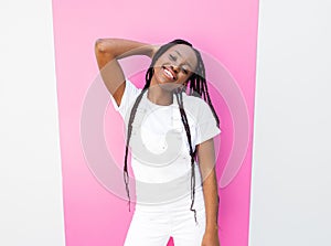 Cheerful girl in a white overall leaning pink stripe