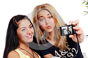 Cheerful girlfriends with photo camera