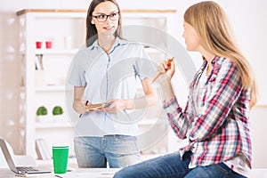 Cheerful girls working in office