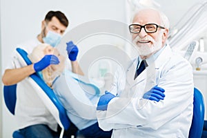 Cheerful glance of pleased stomatologist