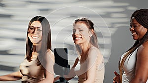 Cheerful glowing girls dancing and having fun in studio