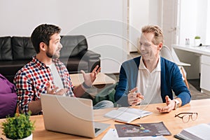 Cheerful good looking men having a conversation