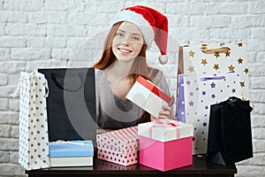 Cheerful gorgeous girl has bought presents for friends on Christmas