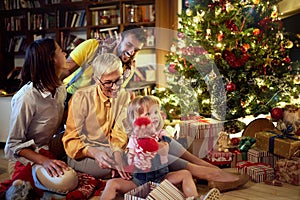 Cheerful grandmather and little girl together for Christmas