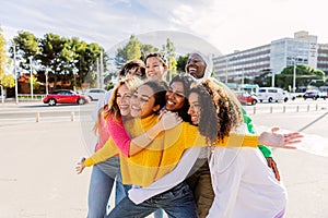 Cheerful group of diverse young girls bonding together outdoors.