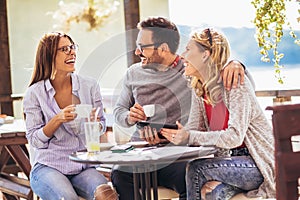 Cheerful group of friends having fun in cafe