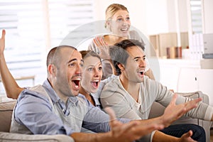 Cheerful group of friends watching football match