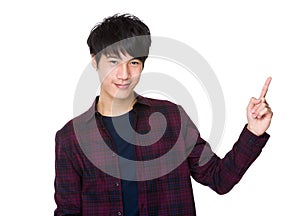 Cheerful guy pointing at something interesting