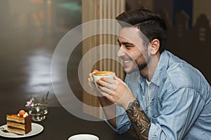 Cheerful Guy Smiling To Girlfriend Having Coffee In Cafe