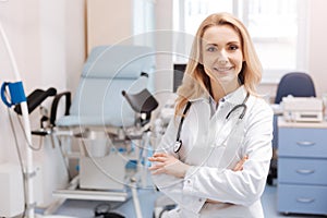 Cheerful gynecologist waiting for the next patient in the cabinet