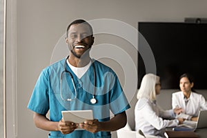 Cheerful handsome African American doctor professional portrait