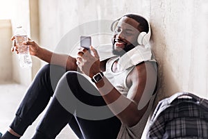 Cheerful handsome african sportsman in process of recreation