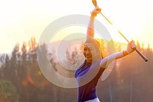 Cheerful happy asian smiling woman with a golf in the golf club in the sunny and evening sunset time, copy space.