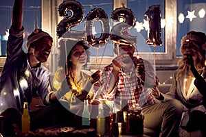 Cheerful and happy couples celebrating New Year eve. New Year, home party, friends time together