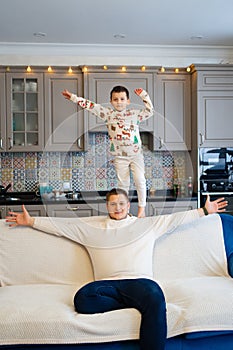 cheerful and happy dad and son fool around and play at home. family happiness.