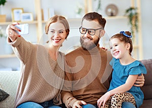 . cheerful happy family mother father and child take selfies, take pictures