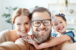 Cheerful happy family mother father and child take selfies, take pictures