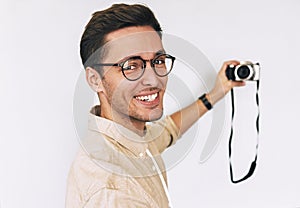 Cheerful happy freelancer young man taking selfie over white studio background and looking to the camera. Young male smiling and