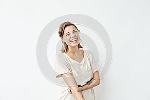Cheerful happy young beautiful girl looking at camera smiling laughing over white background.