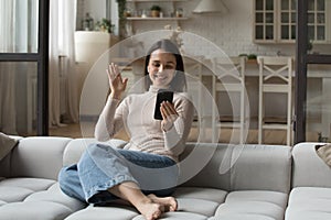 Cheerful happy young millennial woman excited with video call talk