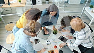 Cheerful and hard-working employees discussing business ideas working in modern office