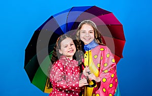 Cheerful hipster children, sisterhood. autumn fashion. happy little girls with colorful umbrella. rain protection