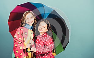 Cheerful hipster children, sisterhood. rain protection. Rainbow. autumn fashion. happy little girls with colorful