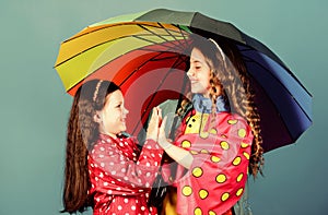 Cheerful hipster children, sisterhood. rain protection. Rainbow. family bonds. Little girls in raincoat. happy little