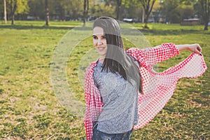 Cheerful hipster woman in park