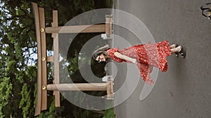 Cheerful hispanic woman in glasses twirling in japanese dress at meiji shrine, capturing tokyo\'s urban travel culture with a danc