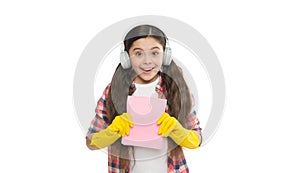 Cheerful housewife. small girl earphones in yellow rubber gloves. happy cleaning sunday. listen music while housekeeping