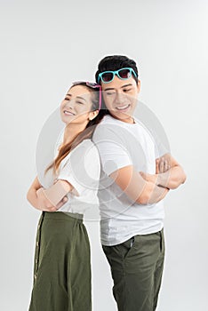 Cheerful hsppy man and woman with crossed hands standing back to back