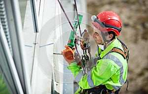 Cheerful industrial climber during winterization works photo