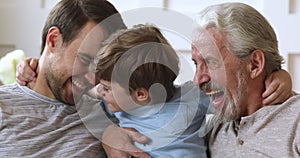 Cheerful intergenerational men family laughing hugging bonding, closeup portrait