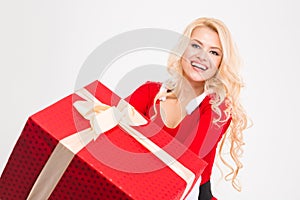 Cheerful joyful female smiling and holding big red present box