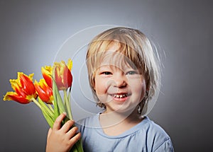 Cheerful kid with a bouquet