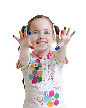 Cheerful kid girl showing her hands painted in bright colors