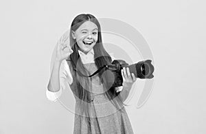 cheerful kid girl take photo with digicam show ok gesture, photography