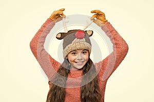 Cheerful kid. Playful cutie. Adorable baby wear cute winter knitted hat. Cute reindeer with red nose. Cute accessories