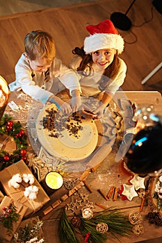 Cheerful kids making the christmas gingerbread