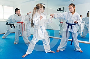 Cheerful kids sparring in pairs